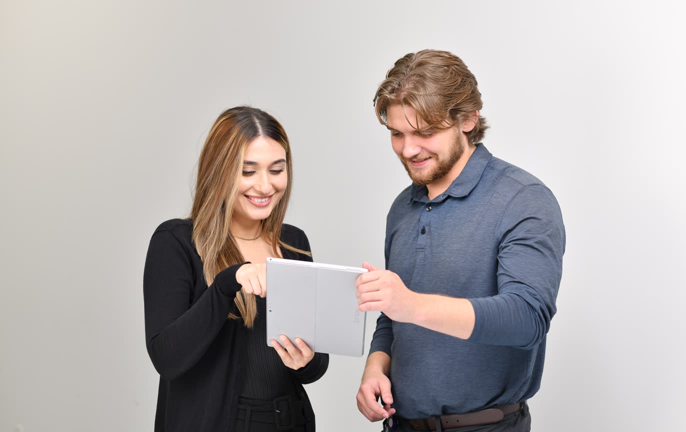 Two Mevotech employees looking at a tablet together